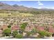 Overhead shot of properties in a community surrounded by native vegetation with mountains in the distance at 19829 N 97Th St, Scottsdale, AZ 85255