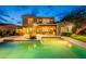 Beautiful backyard featuring a pool, covered patio, built in bar, and lush green grass at 19829 N 97Th St, Scottsdale, AZ 85255