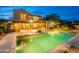 Beautiful backyard featuring a pool, covered patio, built in bar, and lush green grass at 19829 N 97Th St, Scottsdale, AZ 85255