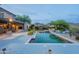 Resort style backyard features a swimming pool, cozy seating, and desert landscape with mountain views at 19829 N 97Th St, Scottsdale, AZ 85255