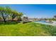 Expansive backyard with grassy lawn, desert landscape, pool and scenic views at 19829 N 97Th St, Scottsdale, AZ 85255