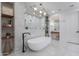Open bathroom with a freestanding tub, modern lighting, and a glass enclosed shower at 19829 N 97Th St, Scottsdale, AZ 85255
