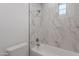 Modern bathroom featuring white marble-style tiled walls and bathtub at 19829 N 97Th St, Scottsdale, AZ 85255