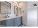 Stylish bathroom featuring double sinks, marble countertops, and decorative floor tiles at 19829 N 97Th St, Scottsdale, AZ 85255
