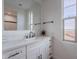 Bright bathroom featuring white cabinetry, quartz countertops, and modern black hardware fixtures at 19829 N 97Th St, Scottsdale, AZ 85255