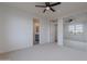 Spacious bedroom with an ensuite bathroom, natural light, and mirrored closet doors at 19829 N 97Th St, Scottsdale, AZ 85255