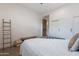Minimalist bedroom with neutral tones, simple decor and ensuite access at 19829 N 97Th St, Scottsdale, AZ 85255