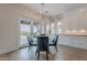 Bright dining area with a modern light fixture, glass table and seamless indoor/outdoor living at 19829 N 97Th St, Scottsdale, AZ 85255