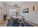 Dining room with modern chandelier, stylish table decor, plantation shutters and a cool-toned color scheme at 19829 N 97Th St, Scottsdale, AZ 85255