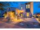Charming two-story home features a brick pathway, desert landscaping, and warm exterior lighting at 19829 N 97Th St, Scottsdale, AZ 85255