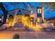 Charming home featuring a brick walkway, desert landscaping, and warm exterior lighting at 19829 N 97Th St, Scottsdale, AZ 85255