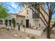 Charming home with desert landscaping, a brick patio, and a lovely tree in the front yard at 19829 N 97Th St, Scottsdale, AZ 85255