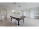 Bright game room featuring a pool table, with built in desks, and natural light at 19829 N 97Th St, Scottsdale, AZ 85255