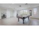 Spacious game room with a pool table, natural light, and mountain views at 19829 N 97Th St, Scottsdale, AZ 85255