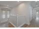 Bright hallway with wooden floors, leading to a window overlooking a tile roof at 19829 N 97Th St, Scottsdale, AZ 85255