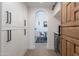 Hallway view with custom cabinetry, a wine fridge, arched doorways, and designer touches for a luxurious feel at 19829 N 97Th St, Scottsdale, AZ 85255