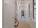 Elegant hallway with hardwood floors, arched ceilings, and modern globe pendant lighting at 19829 N 97Th St, Scottsdale, AZ 85255