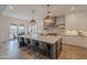 Open kitchen with a large island, stainless appliances, pendant lights, and seamless access to the dining area at 19829 N 97Th St, Scottsdale, AZ 85255