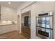 Close-up of a kitchen with stainless steel appliances, custom cabinetry, and an arched doorway at 19829 N 97Th St, Scottsdale, AZ 85255