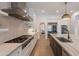 Well-lit kitchen features a gas range, stainless steel appliances, white cabinets, and a marble island for cooking and entertaining at 19829 N 97Th St, Scottsdale, AZ 85255