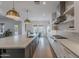 Bright kitchen with a large marble island, stainless steel appliances, and white cabinetry that complements the light wood floors at 19829 N 97Th St, Scottsdale, AZ 85255