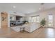 Spacious living room featuring a large window view, light wood floors, and a custom entertainment center at 19829 N 97Th St, Scottsdale, AZ 85255