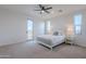 Bright main bedroom with carpet flooring and a large window and ensuite access at 19829 N 97Th St, Scottsdale, AZ 85255