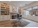 Bright office with a modern desk, comfortable seating, built-in shelving and fireplace at 19829 N 97Th St, Scottsdale, AZ 85255