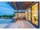 Covered outdoor kitchen with stainless steel grill and marble countertops for relaxed entertaining at 19829 N 97Th St, Scottsdale, AZ 85255