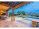 Outdoor living area features a beautiful pool, comfortable seating and stunning mountain views at 19829 N 97Th St, Scottsdale, AZ 85255