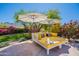 Inviting outdoor lounge area with cushioned seating, umbrellas, and lush landscaping provides a tranquil setting at 19829 N 97Th St, Scottsdale, AZ 85255
