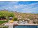 Resort style pool area with desert views, stylish seating, sunbeds, and lush green landscape at 19829 N 97Th St, Scottsdale, AZ 85255