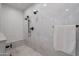 Modern shower with white and pebble tile, dual shower heads, and sleek black fixtures at 19829 N 97Th St, Scottsdale, AZ 85255