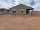 The backyard has ample space that is surrounded by a block wall and has an exterior view of the covered patio at 20795 N Roadrunner Ln, Maricopa, AZ 85138