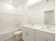 Bright bathroom featuring a double sink vanity and shower-tub combo at 20795 N Roadrunner Ln, Maricopa, AZ 85138