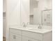 Bright bathroom featuring double vanity sinks, white cabinetry, quartz countertop, and glass shower at 20795 N Roadrunner Ln, Maricopa, AZ 85138