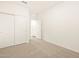 Bedroom with plush carpet, white trim, and closet with sliding doors at 20795 N Roadrunner Ln, Maricopa, AZ 85138