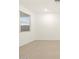 An airy bedroom with tile floors is illuminated with natural light from a window with horizontal blinds at 20795 N Roadrunner Ln, Maricopa, AZ 85138