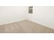 Bright bedroom with neutral carpet and a window providing natural light at 20795 N Roadrunner Ln, Maricopa, AZ 85138