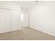 Bedroom with plush carpet, white trim, and closet with sliding doors at 20795 N Roadrunner Ln, Maricopa, AZ 85138