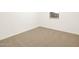 Bright bedroom with neutral carpet and window providing natural light at 20795 N Roadrunner Ln, Maricopa, AZ 85138