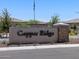 Community entrance sign for Copper Ridge featuring decorative stone and landscaping at 20795 N Roadrunner Ln, Maricopa, AZ 85138