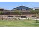 Community green space featuring park benches, decorative landscaping, and lush green grass at 20795 N Roadrunner Ln, Maricopa, AZ 85138