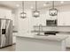 Modern kitchen featuring white cabinets, stainless steel appliances, granite countertops, and island sink at 20795 N Roadrunner Ln, Maricopa, AZ 85138