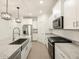 Bright kitchen featuring white cabinets, stainless steel appliances, granite countertops, and a large island at 20795 N Roadrunner Ln, Maricopa, AZ 85138