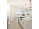 Open-concept kitchen with granite countertops, stainless steel appliances and overhead pendant lights at 20795 N Roadrunner Ln, Maricopa, AZ 85138