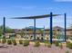 Community playground with shaded play structure, swings, and surrounding landscaping near single Gathering homes at 20795 N Roadrunner Ln, Maricopa, AZ 85138
