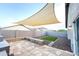 Backyard has artificial grass, brick pavers and a shade covering at 22755 W Yavapai St, Buckeye, AZ 85326