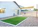 Backyard with artificial grass, stone landscaping, and a shade covering at 22755 W Yavapai St, Buckeye, AZ 85326