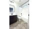 Bathroom featuring a single vanity, toilet, and shower-tub combination with white tile surround at 22755 W Yavapai St, Buckeye, AZ 85326